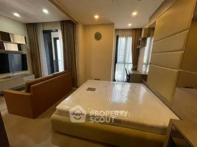 Modern bedroom with stylish decor and large windows in a contemporary apartment.