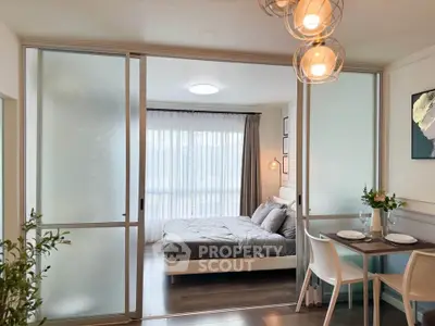 Modern studio apartment with sliding glass doors and stylish dining area