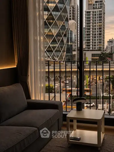 Modern living room with city view from balcony, featuring cozy sofa and stylish decor.