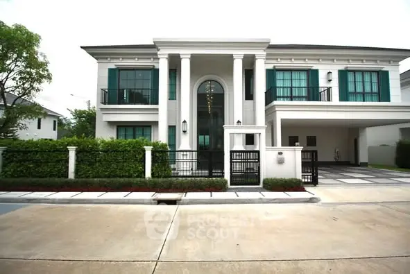 Elegant modern house with grand entrance and lush greenery