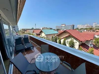 Spacious balcony with city view, perfect for relaxation and outdoor dining.