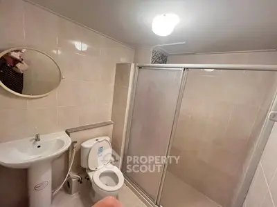 Spacious bathroom with modern shower and elegant fixtures in a stylish real estate property.