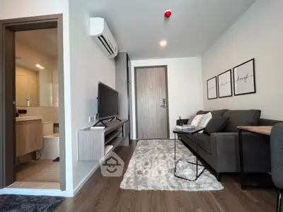 Modern living room with cozy sofa and stylish decor in a contemporary apartment.