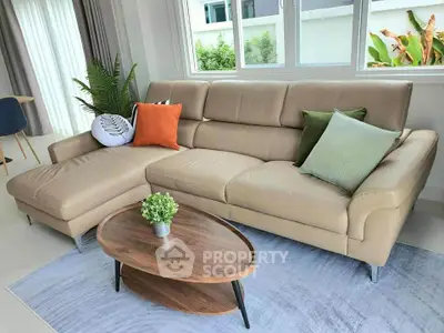 Stylish living room with modern beige sofa and chic coffee table, perfect for relaxation.