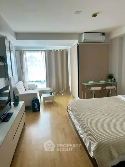 Modern studio apartment with cozy living area and natural light