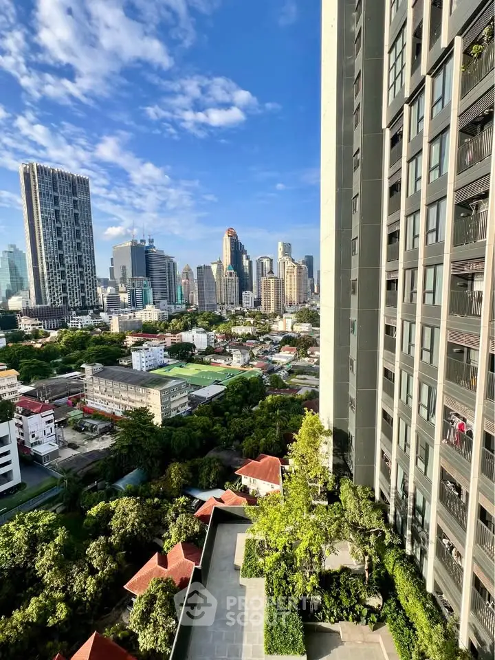 Stunning cityscape view from high-rise building with lush greenery and modern architecture.