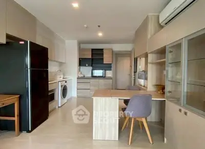 Modern kitchen with sleek cabinetry, dining area, and integrated appliances in a stylish open layout.
