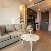 Modern living room with stylish sofa and open kitchen layout