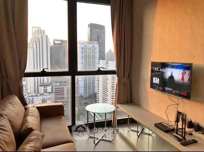 Modern living room with city view, featuring a cozy sofa and wall-mounted TV.