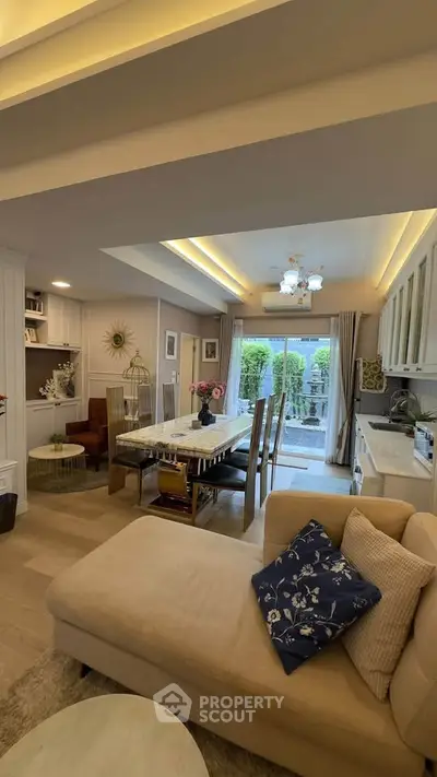 Elegant open-layout living room with dining area and garden view