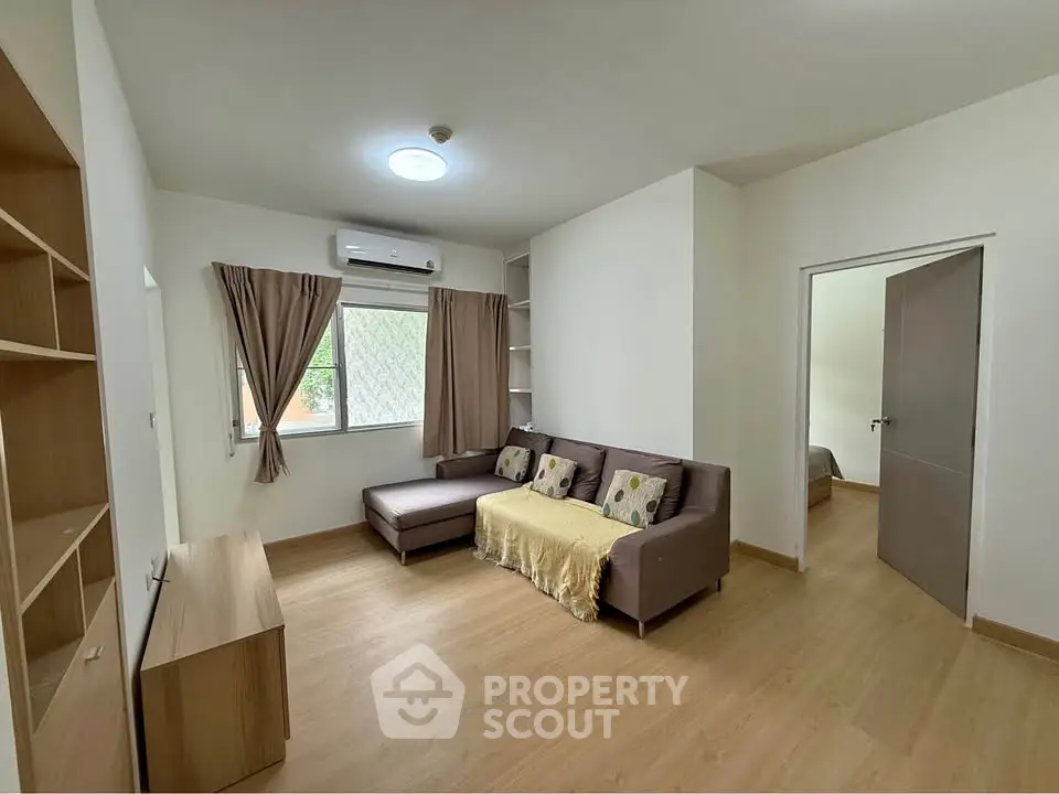 Spacious living room with modern decor and natural light, perfect for relaxation and entertainment.