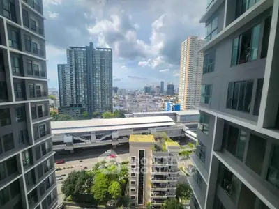 Stunning urban view from high-rise apartment with cityscape and modern buildings.