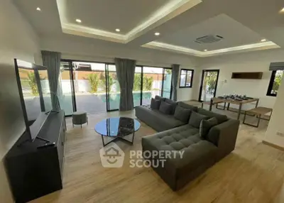 Spacious modern living room with pool view and elegant furnishings
