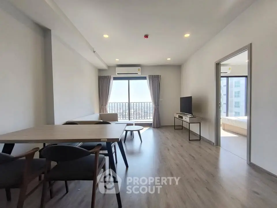 Spacious modern living room with balcony and city view