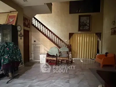Spacious living room with elegant staircase and cozy seating area