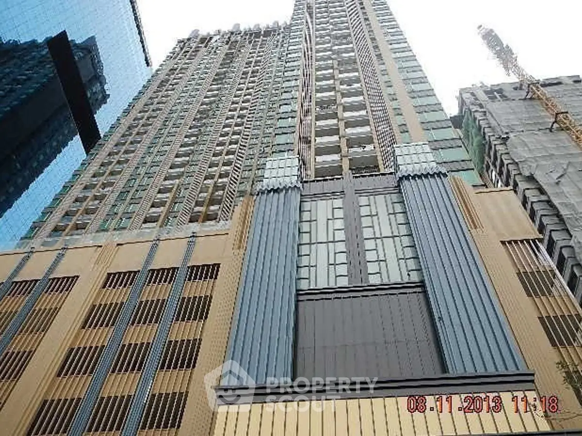 Stunning high-rise building with modern architectural design and glass facade, perfect for urban living.