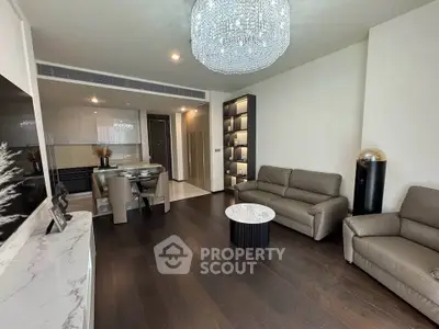 Luxurious living room with elegant chandelier and modern furniture in a stylish apartment.