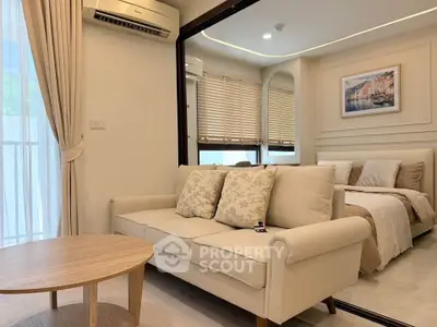 Chic modern living room with cozy sofa and elegant bedroom view, perfect for urban living.