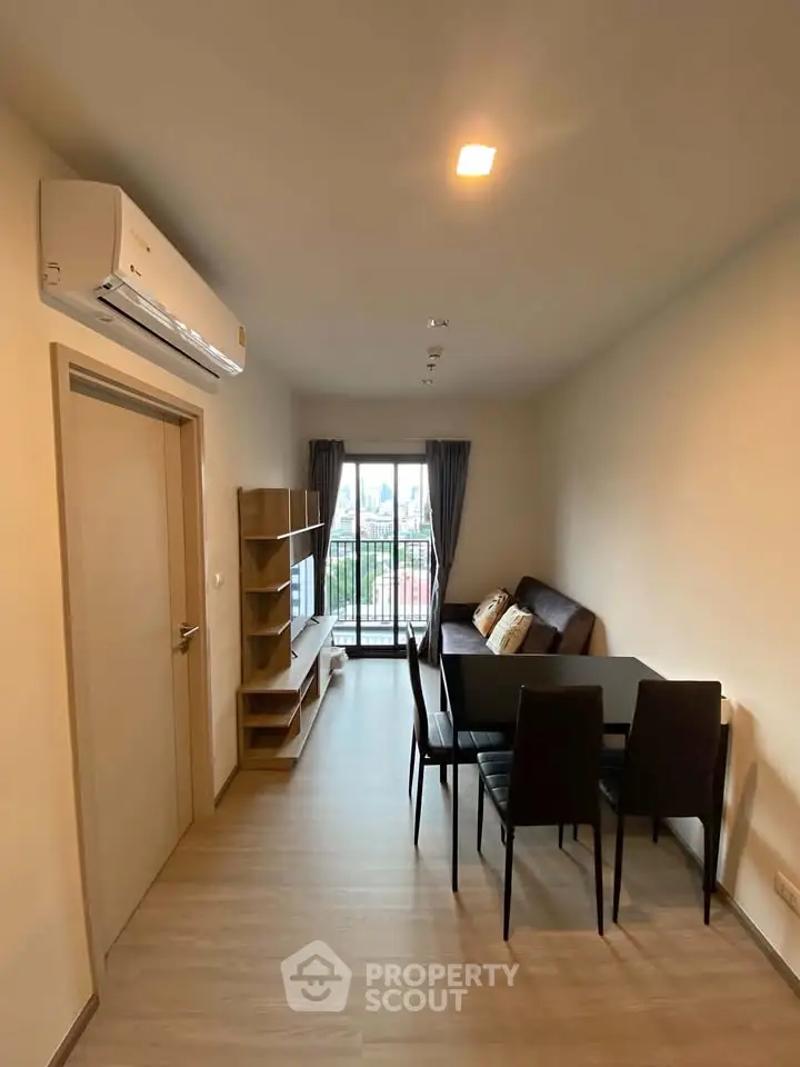 Modern living room with dining area and city view balcony in a stylish apartment.