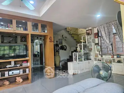 Charming living room with built-in shelves and cozy decor, perfect for family gatherings.