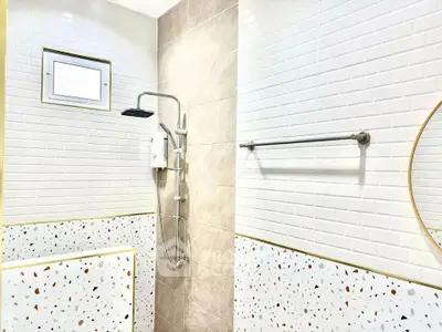 Modern bathroom with terrazzo tiles and sleek shower design