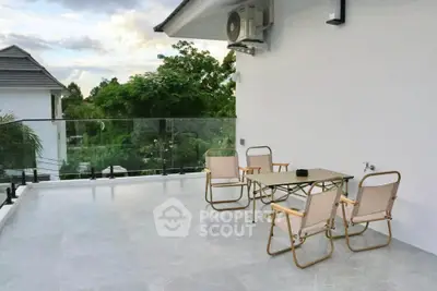 Spacious balcony with outdoor seating and scenic view in modern home