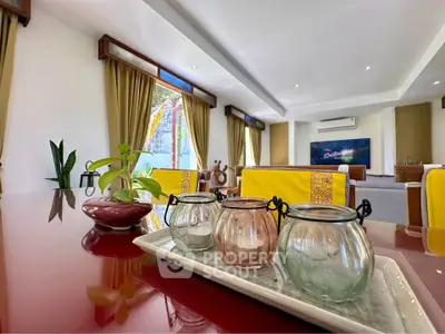 Spacious living room with elegant decor and large windows offering natural light.