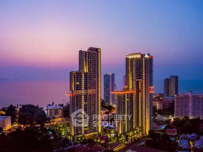 Stunning high-rise buildings with ocean view at sunset, perfect for luxury living.