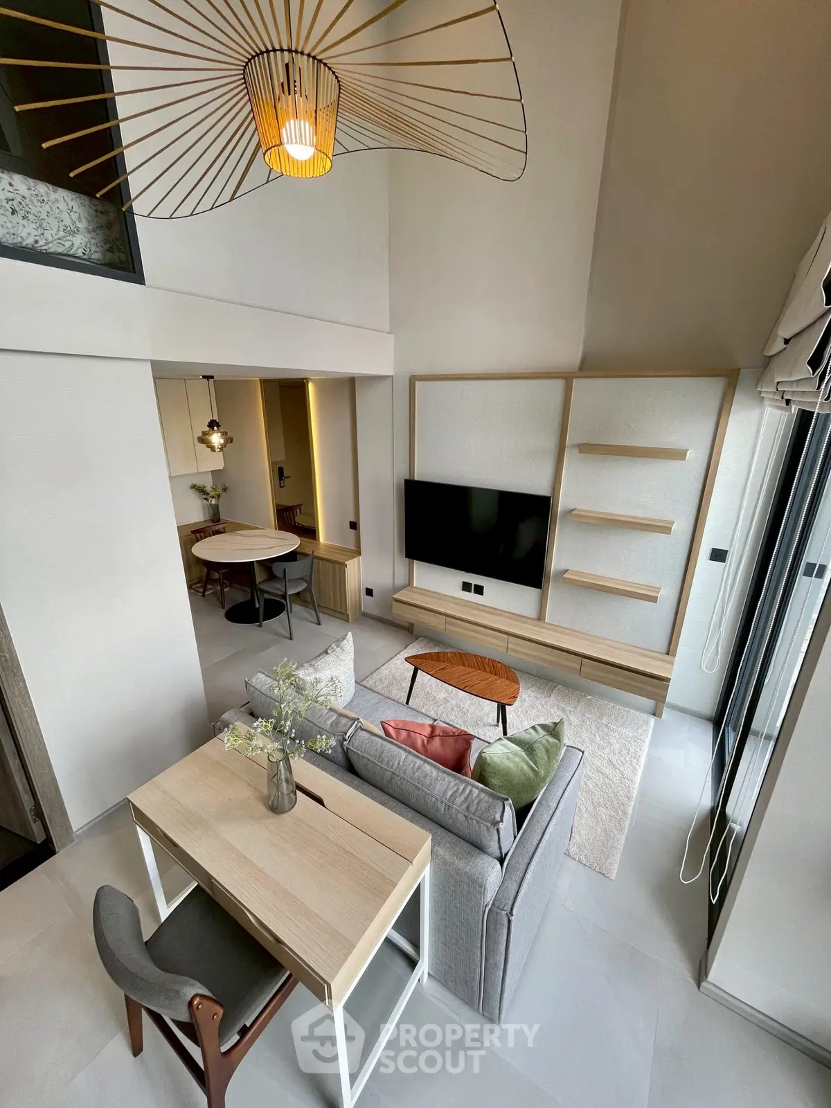 Modern living room with stylish decor and open layout, featuring a cozy seating area and elegant lighting.