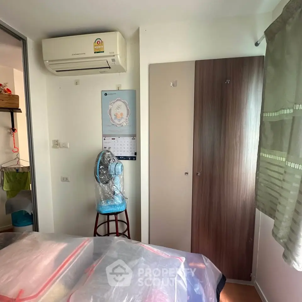 Cozy bedroom with air conditioning and modern decor, perfect for comfortable living.