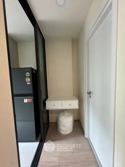 Compact storage area with modern fridge and sleek design
