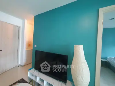 Modern living room with teal accent wall and stylish decor