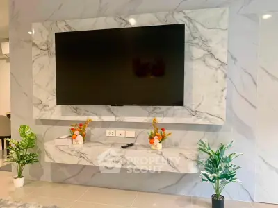 Luxurious living room with marble TV wall and elegant decor