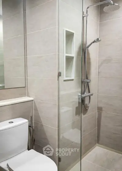 Modern bathroom with sleek shower and toilet in minimalist design
