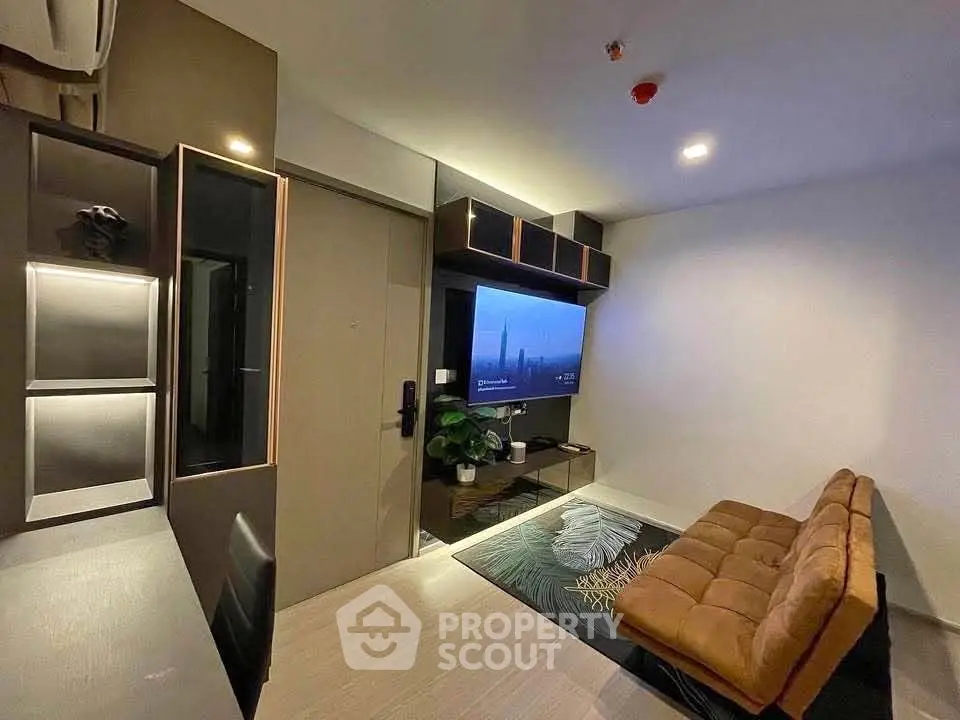 Modern living room with sleek design, featuring a wall-mounted TV and stylish furniture.