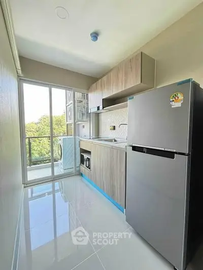 Modern kitchen with sleek appliances and balcony view in a stylish apartment