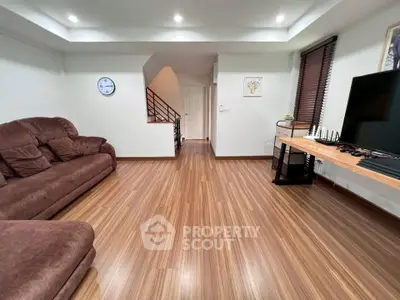 Spacious living room with modern decor and wooden flooring