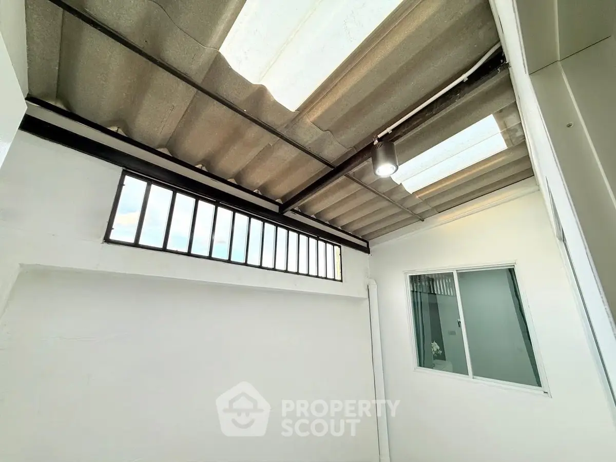 Modern rooftop area with skylight and window, perfect for natural light.