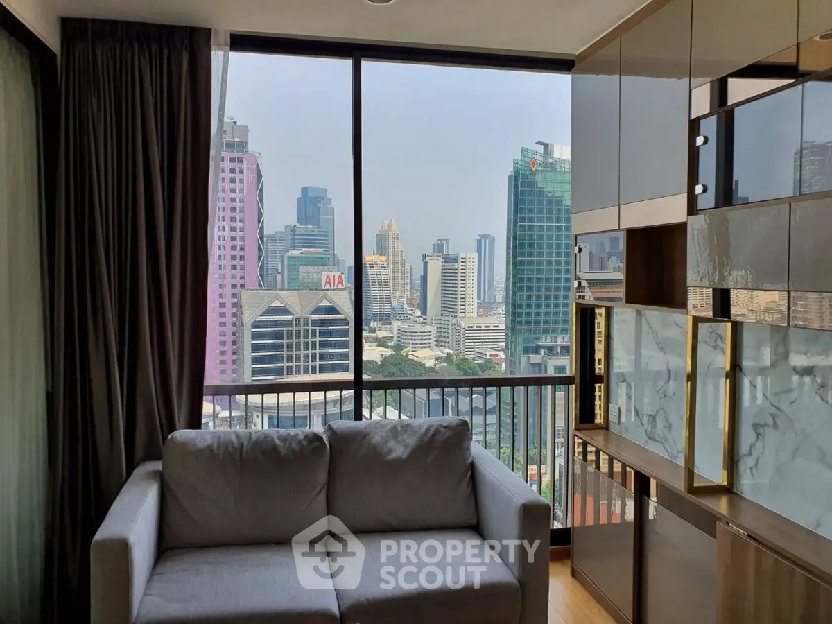 Modern living room with city view, featuring sleek furniture and large windows.