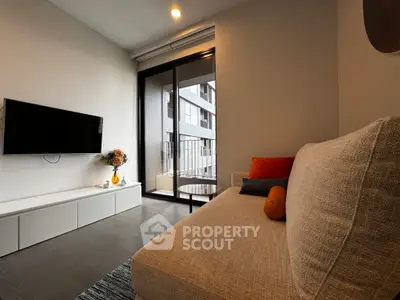 Modern living room with cozy sofa and wall-mounted TV, featuring a balcony view.