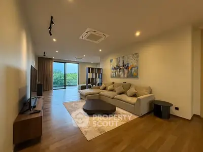 Spacious modern living room with large windows and stylish decor