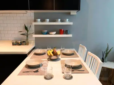 Modern kitchen with stylish dining setup and open shelving