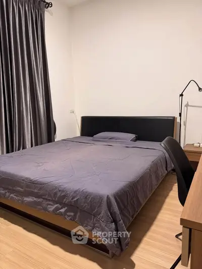 Cozy bedroom with modern furnishings and elegant curtains, perfect for restful nights.
