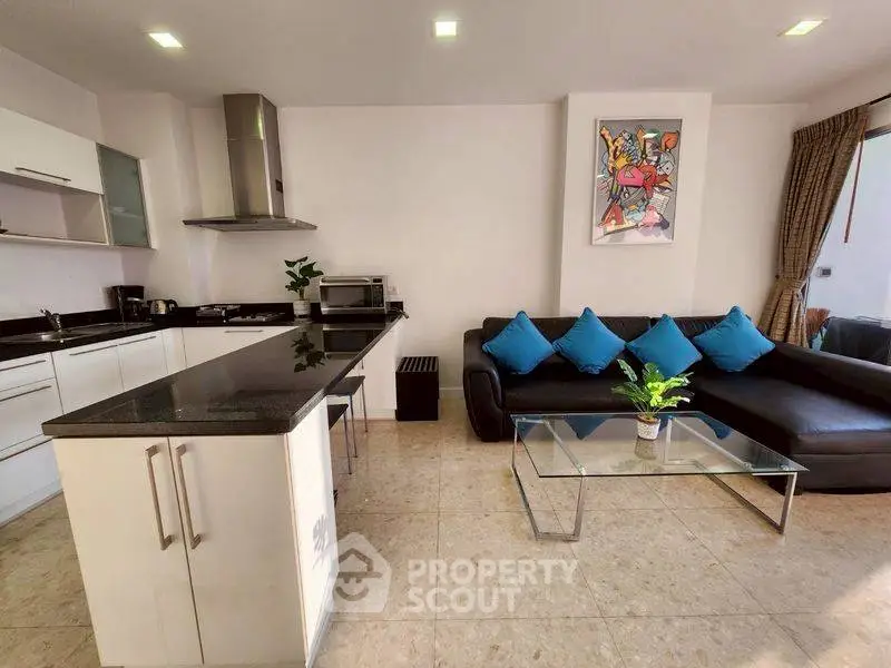 Modern open-layout kitchen and living room with sleek design and vibrant decor.