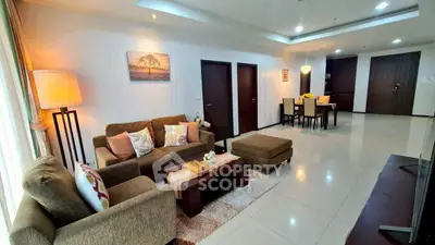 Spacious living room with elegant decor and dining area in modern apartment.
