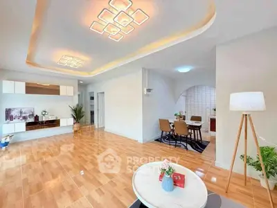 Spacious modern living room with elegant lighting and open dining area