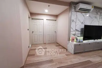 Modern living room with marble accent wall and wooden flooring