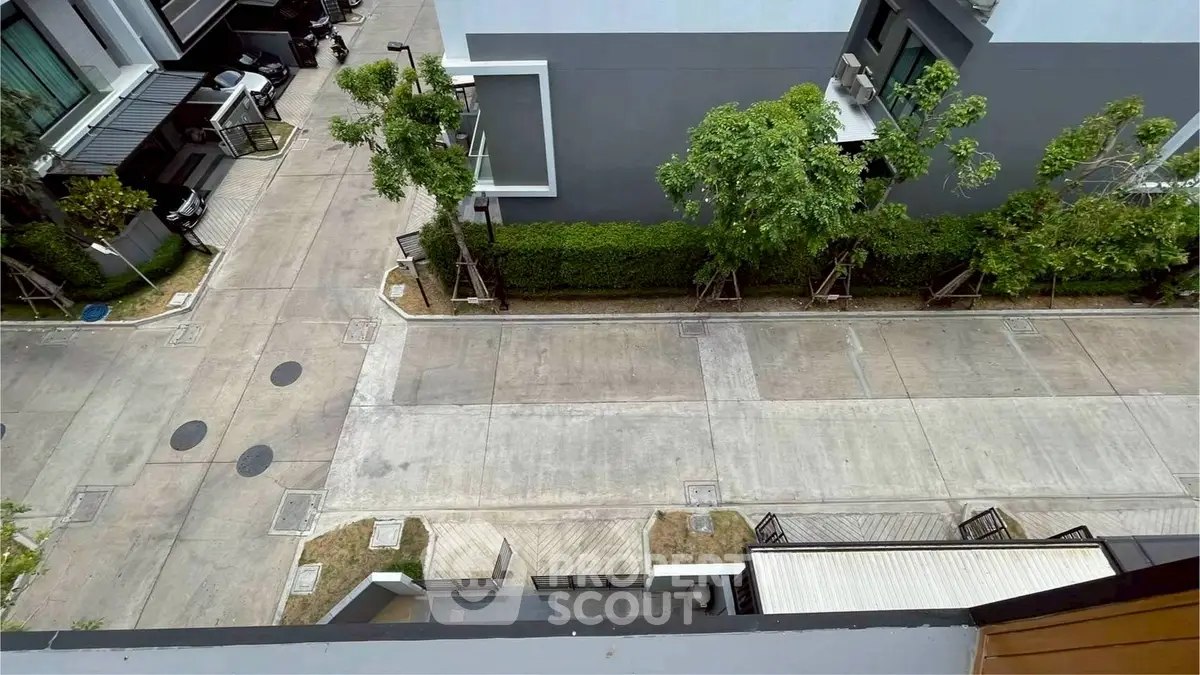Aerial view of modern residential street with greenery and contemporary architecture.