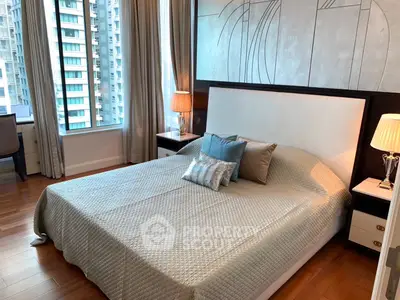 Luxurious bedroom with modern decor and city view, featuring elegant lighting and stylish bedding.