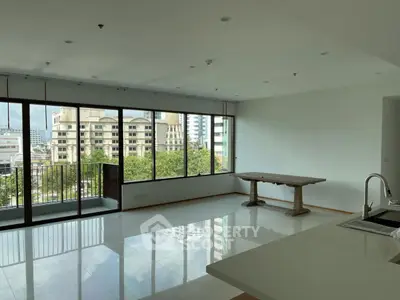 Spacious modern living room with large windows and city view